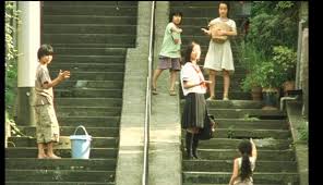 Staircase in Nobody Knows. Several characters are staring at the camera